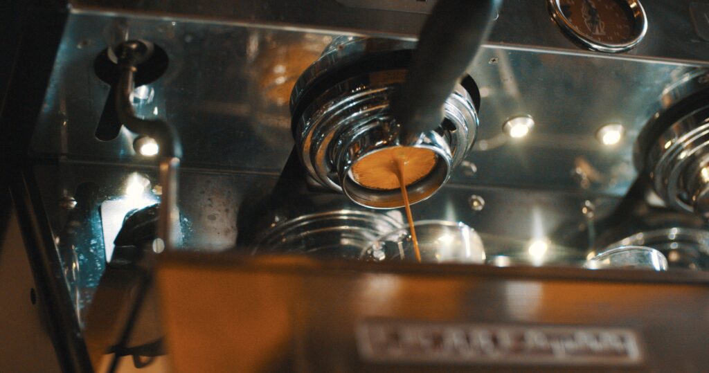 Espresso shot being extracted into a cup with rich crema