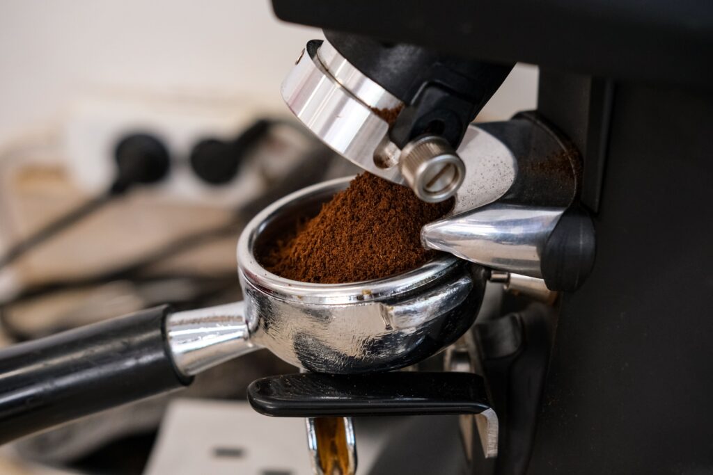 Freshly ground espresso coffee in a portafilter ready for brewing